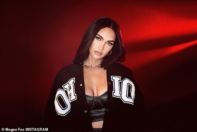 Supportive girlfriend: Megan proved to keep MGK close to her heart as she rocked an Ohio letterman's jacket as part of her new campaign with the fashion brand Boohoo