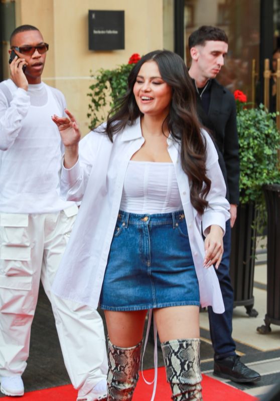 Selena Gomez in a Denim Skirt and Knee-high Snakeskin Boots at Manko in Paris