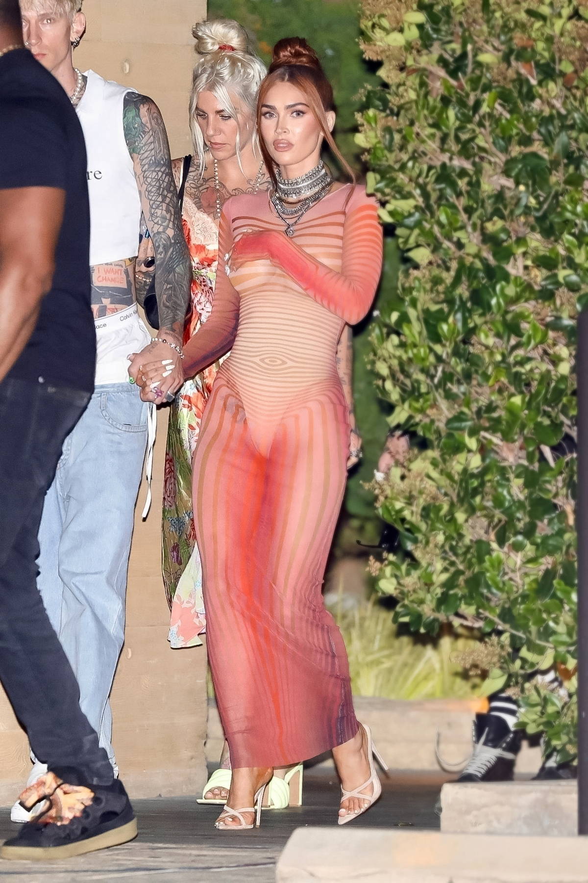 Megan Fox looking radiant in an orange bodycon dress while exiting Nobu in Malibu, California