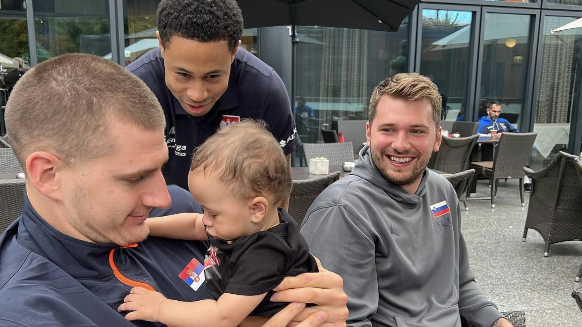 Slaughter posing with NBA stars